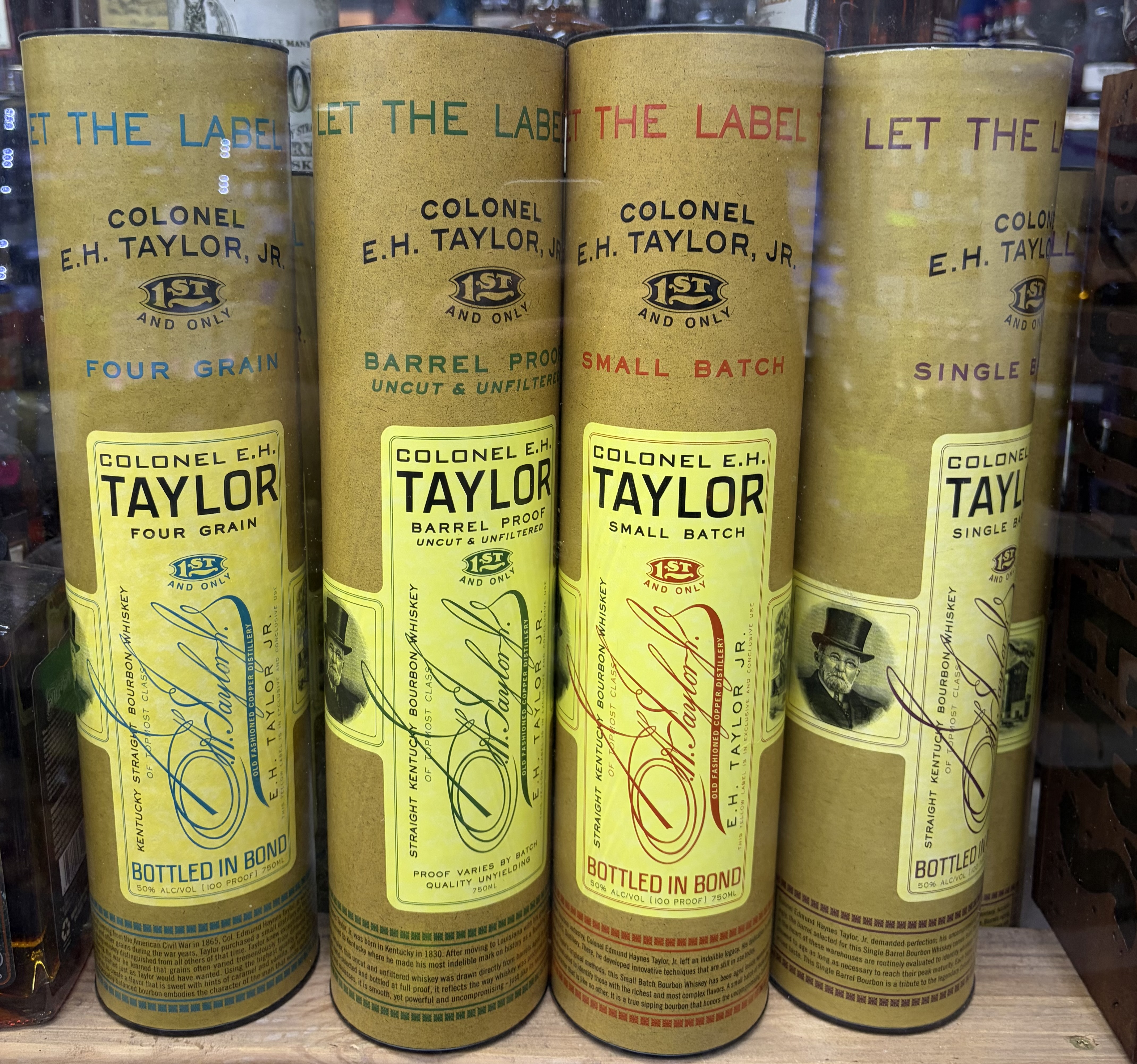 Four Colonel E.H. Taylor gift tubes: Four Grain, Barrel Proof, Small Batch and Single Barrel bourbon.