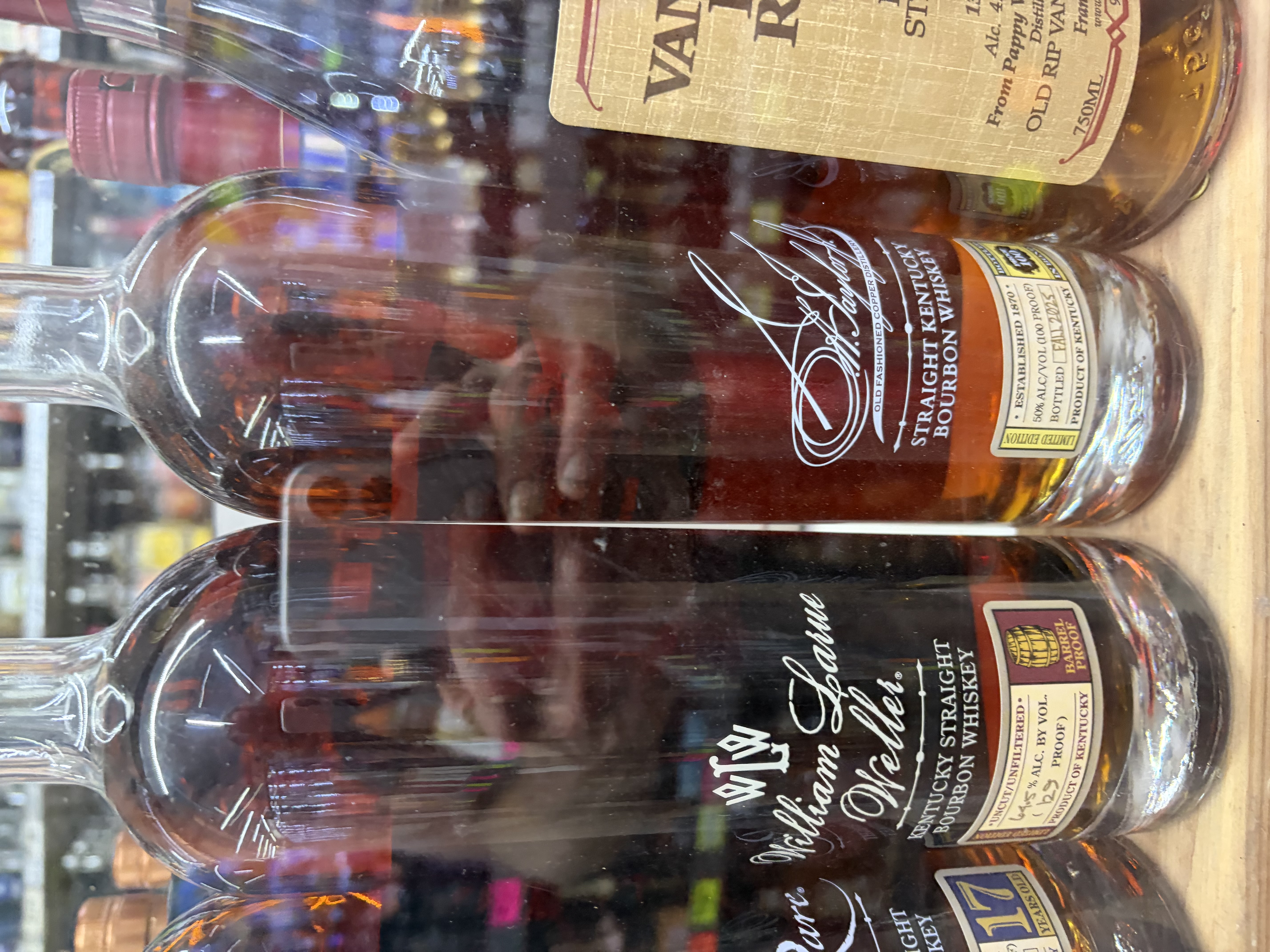 William Larue Weller uncut, unfiltered barrel-proof bourbon beside E.H. Taylor and Old Rip Van Winkle.