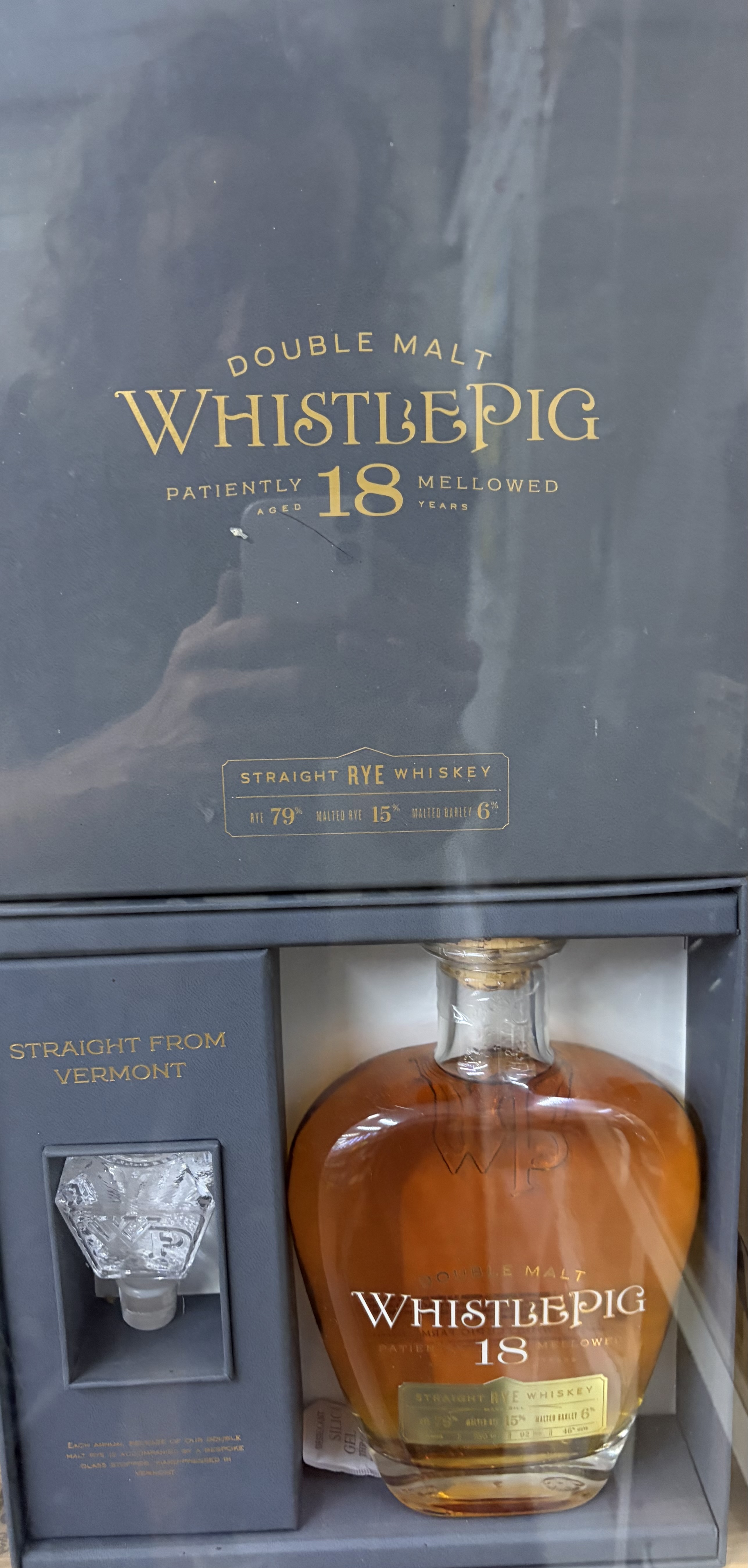 WhistlePig Aged 18 Years Double Malt Straight Rye Whiskey gift box with bottle and glass stopper.