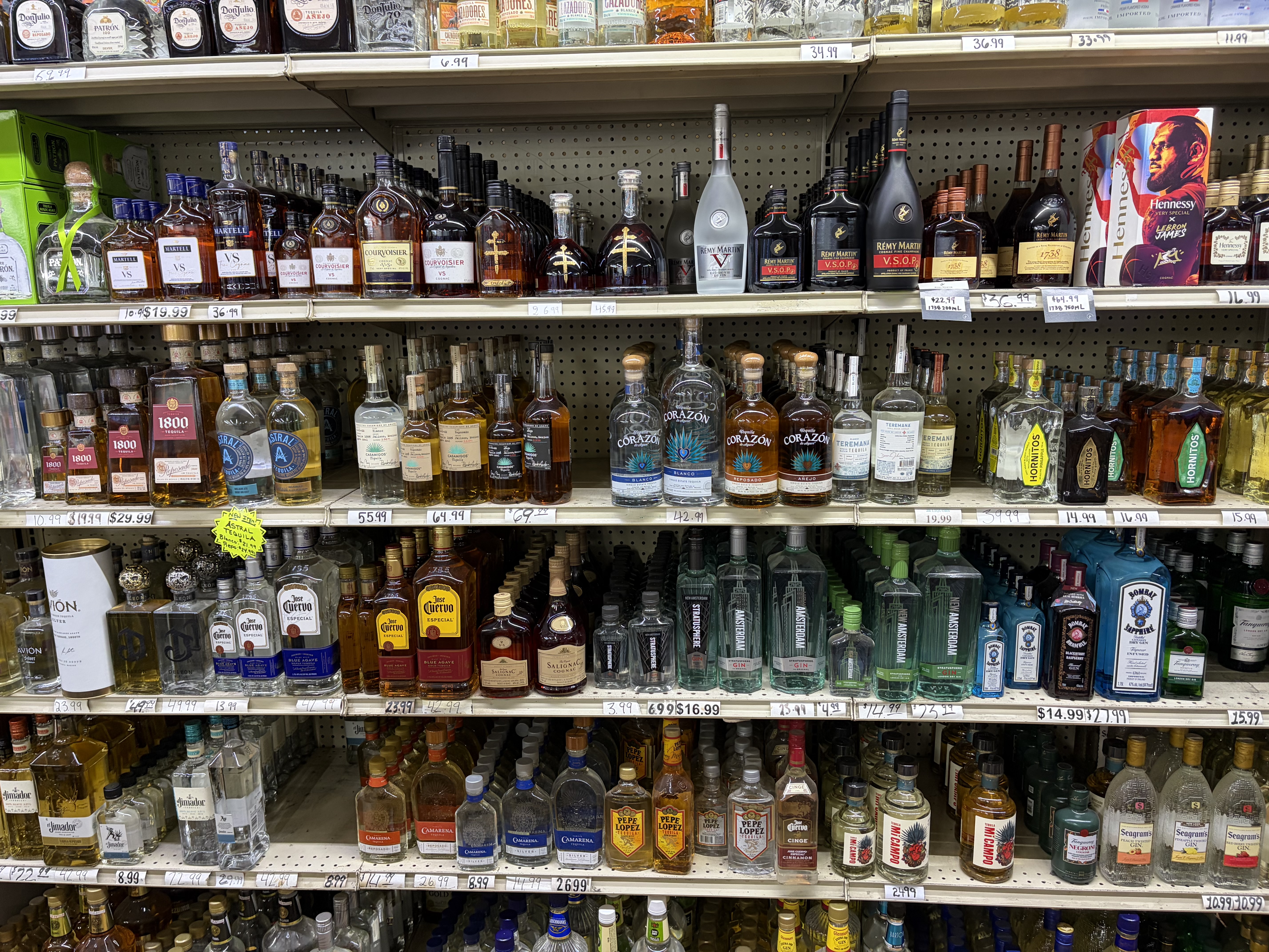 Store shelves of tequila, cognac and gin including Don Julio, Patron, 1800, Hennessy and Remy Martin.