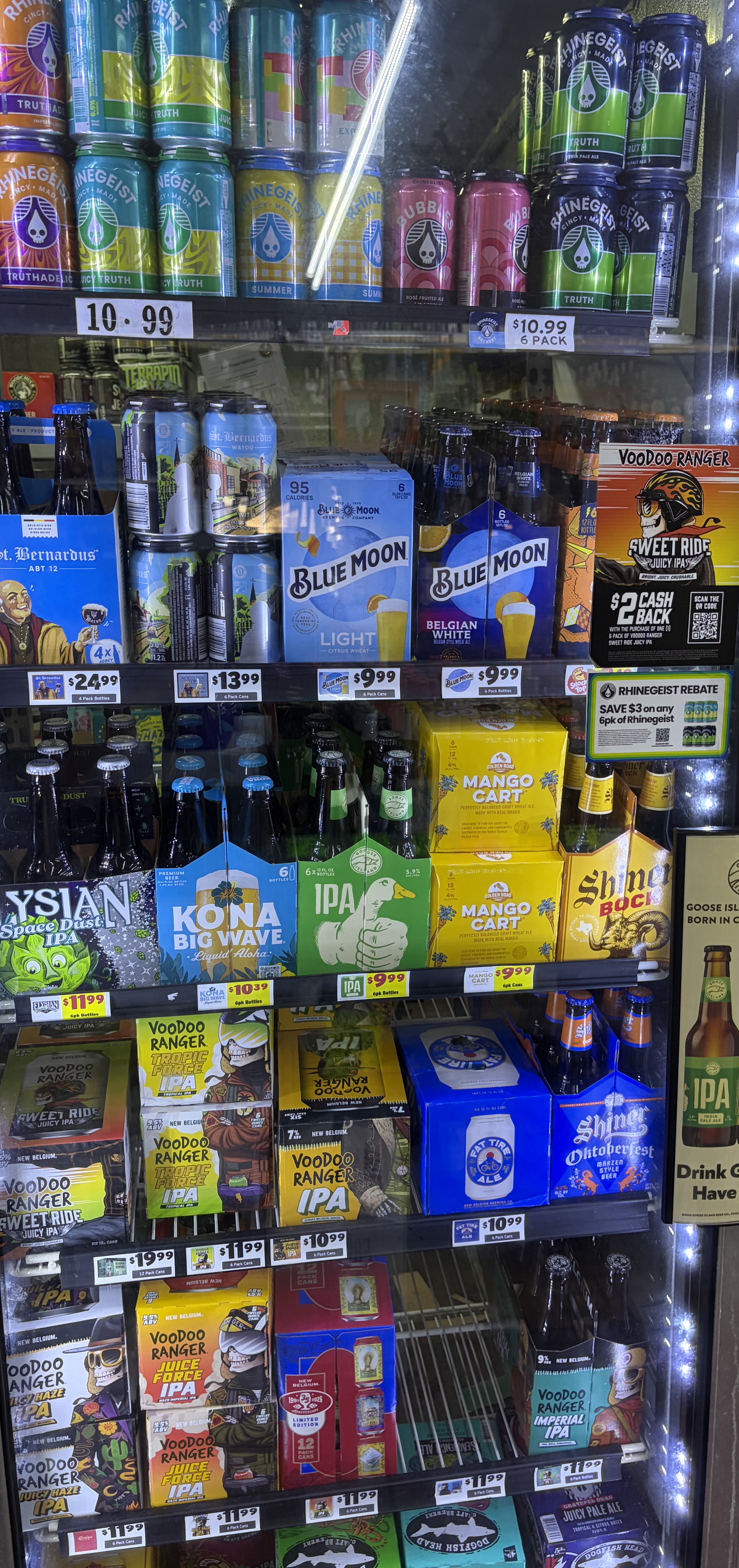 Refrigerated craft beer cans and six-packs including Rhinegeist, Voodoo Ranger and Kona Big Wave.